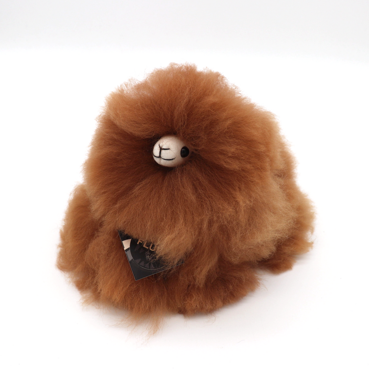 Hazelnut INKARI Monsterfluff alpaca stuffed animal — lifestyle view in cozy home setting